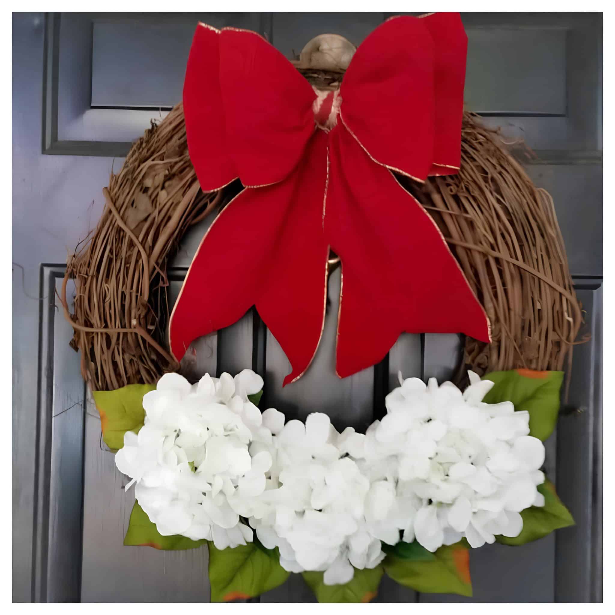 Red Christmas bow on a brown wreath with white flowers and green leaves, ideal for holiday home decor and festive decoration for Christmas seasons.