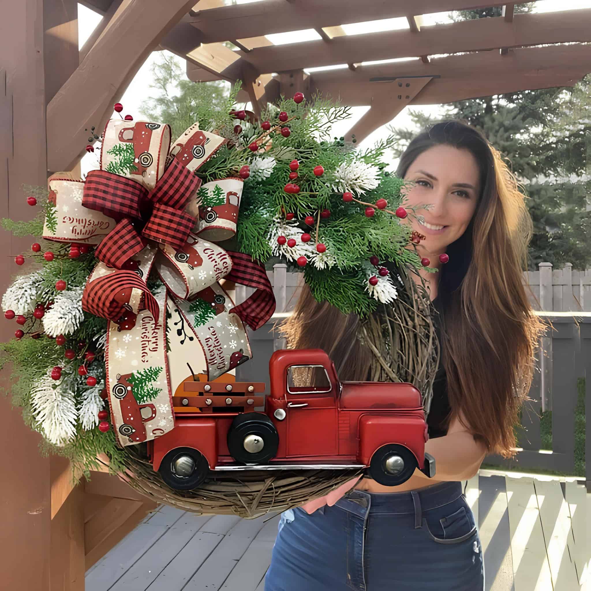 Whimsical wooden grapevine wreath with vintage red truck accent, snowy greens and buffalo plaid bow