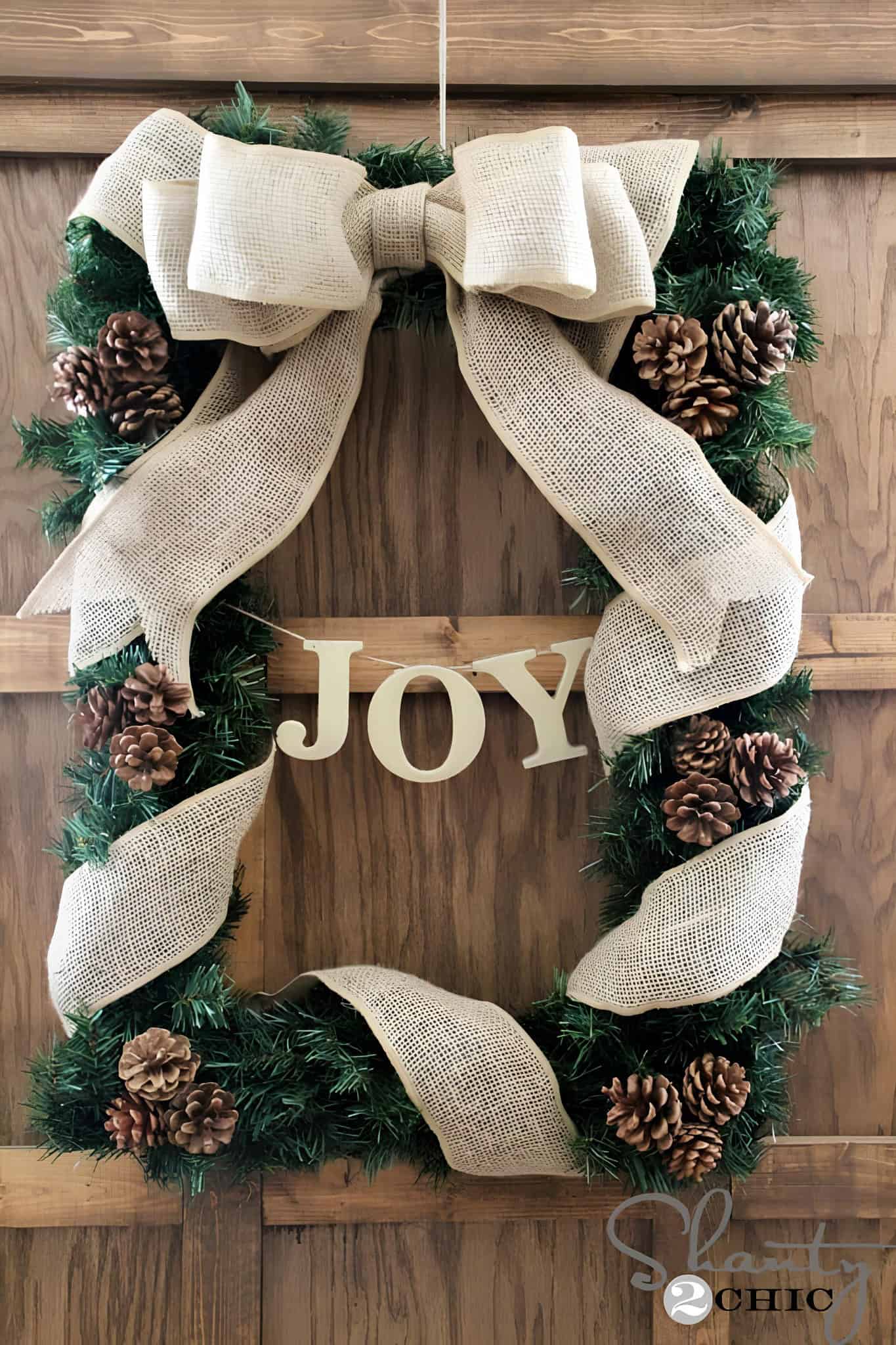 DIY pinecone wreath with bold zigzag ribbon bow