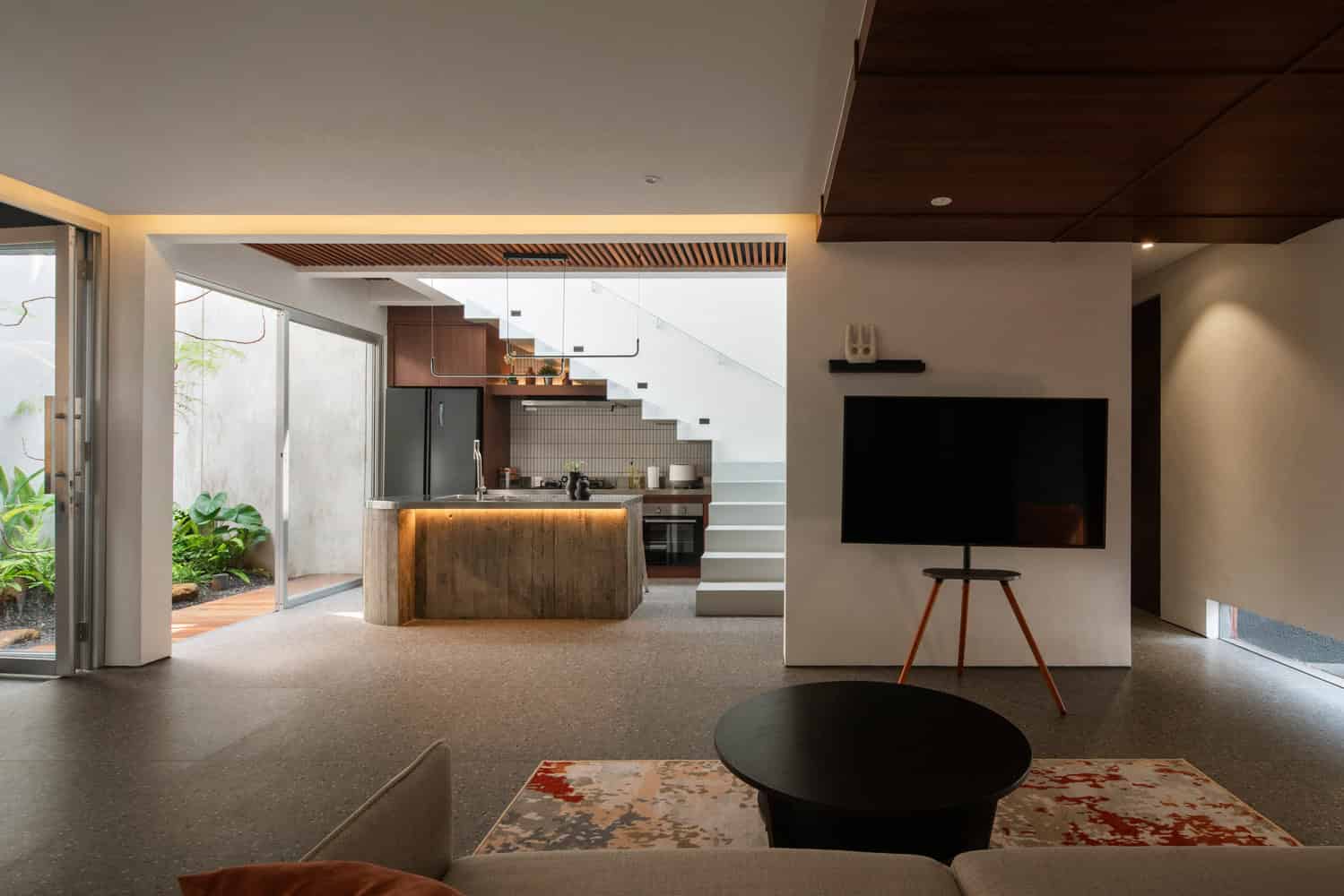 10º House by STUDIE, open kitchen and living area in Jakarta, Indonesia