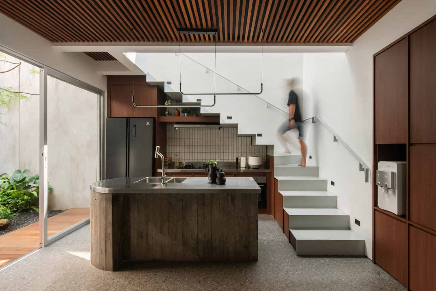 10º House by STUDIE, kitchen island with stair and skylight in Jakarta, Indonesia