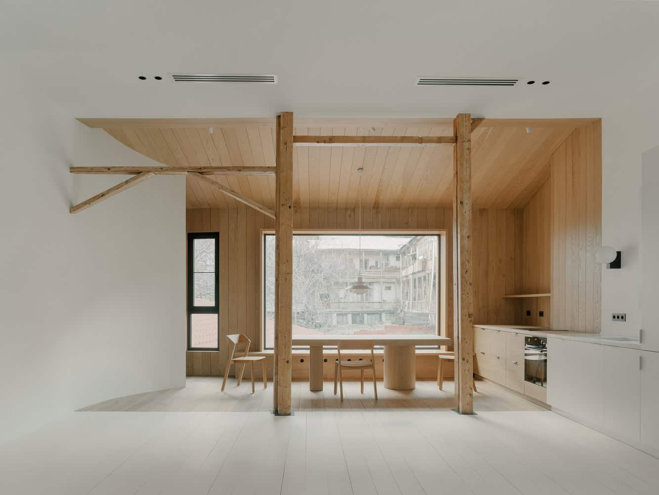 Birdsnest House Dining Room Overview by TIMM Architecture Birdsnest House by TIMM Architecture, full dining room overview with large window in Tbilisi, Georgia