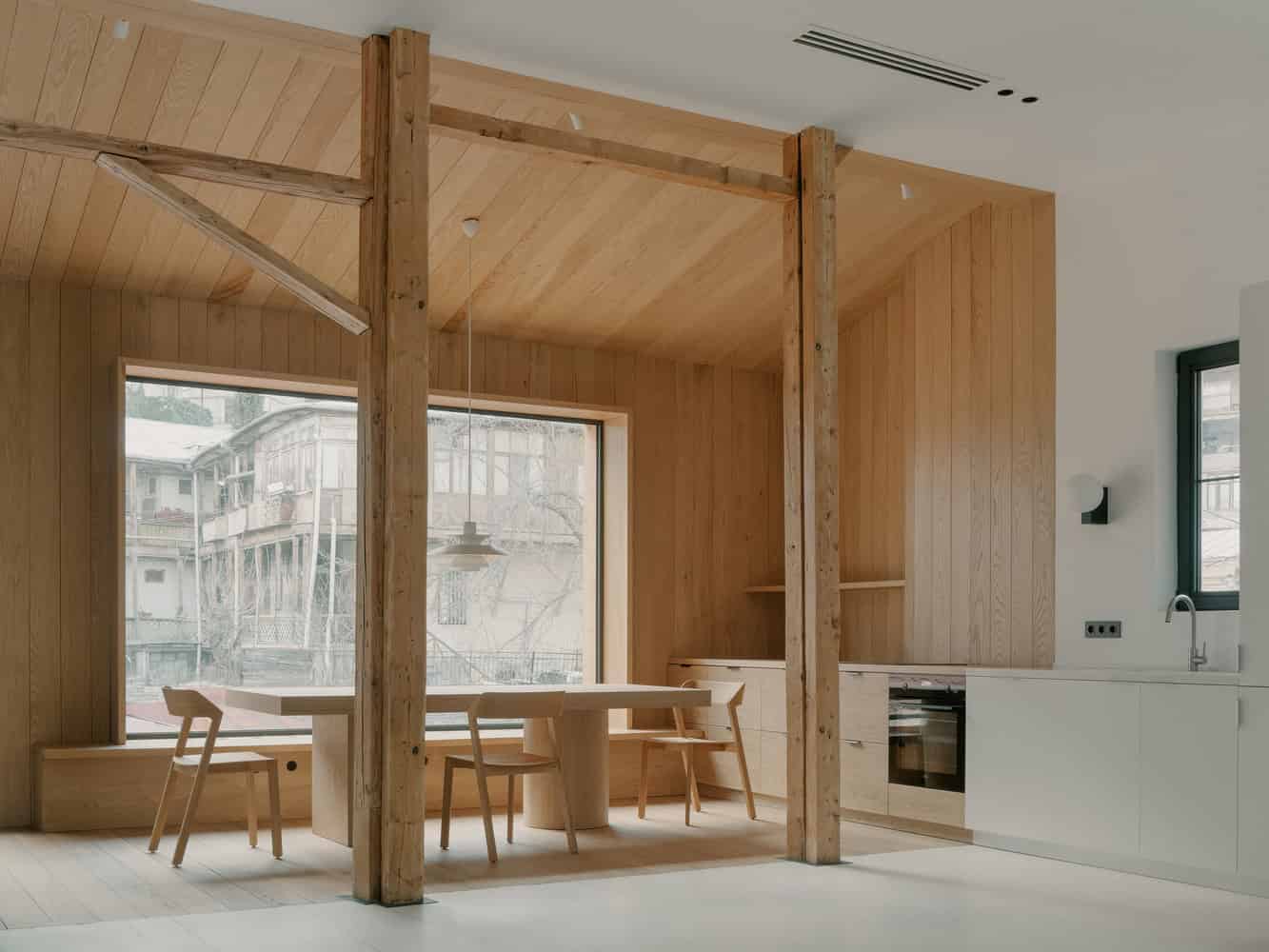 Birdsnest House Kitchen Timber Panels Window by TIMM Architecture Birdsnest House by TIMM Architecture, kitchen with timber panels and large window in Tbilisi, Georgia