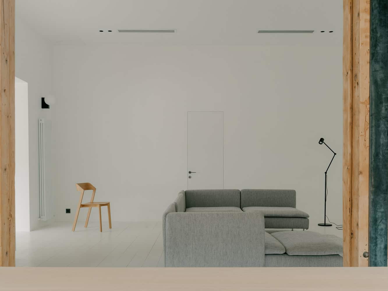 Birdsnest House Living Room Wide View by TIMM Architecture Birdsnest House by TIMM Architecture, wide living room view with chair and lamp in Tbilisi, Georgia