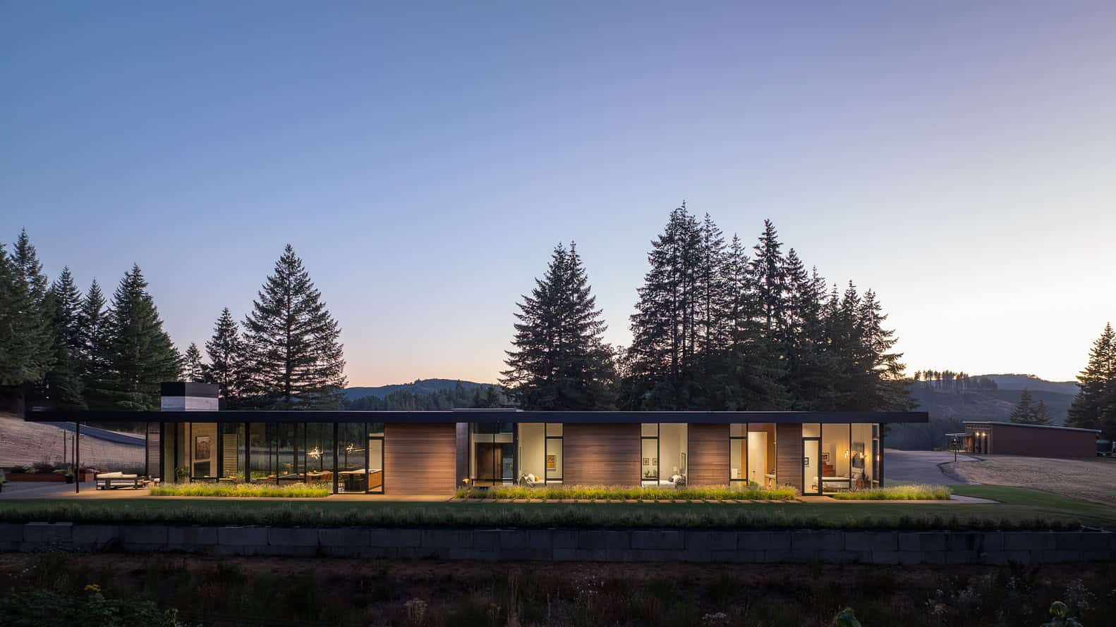 Evening Sky Residence by Scott I Edwards Architecture, long glass elevation at dusk in McMinnville, Oregon, USA
