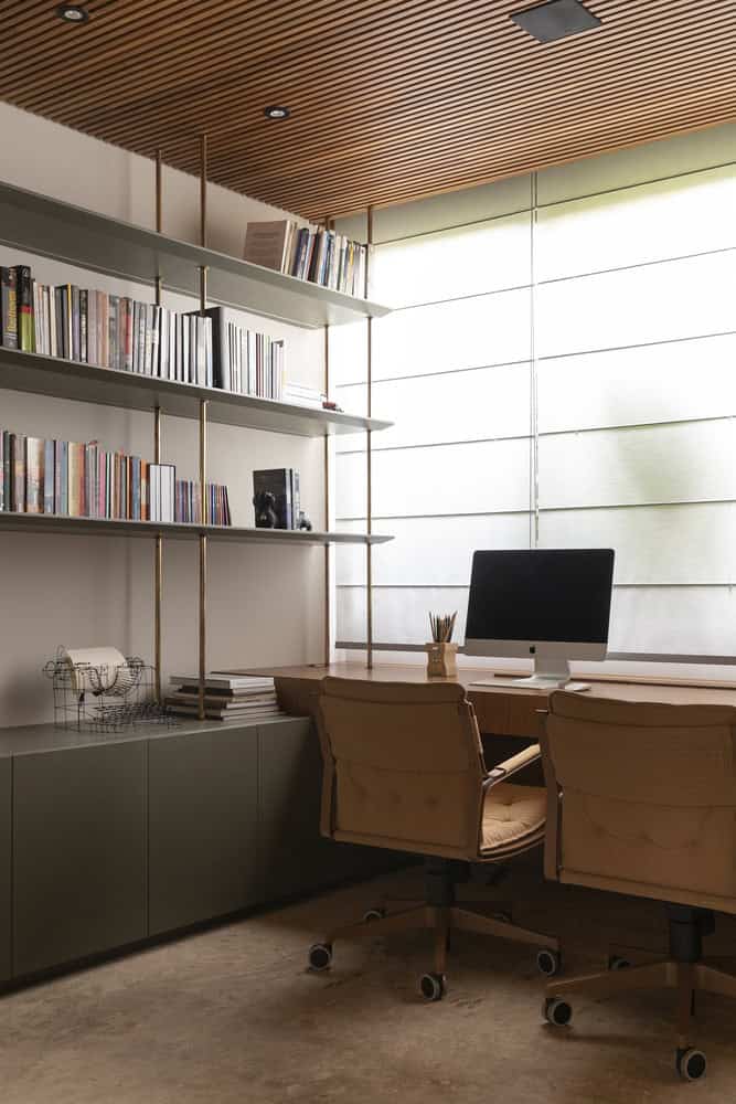 Home office with wood ceiling slats at FE House by N2B Arquitetura