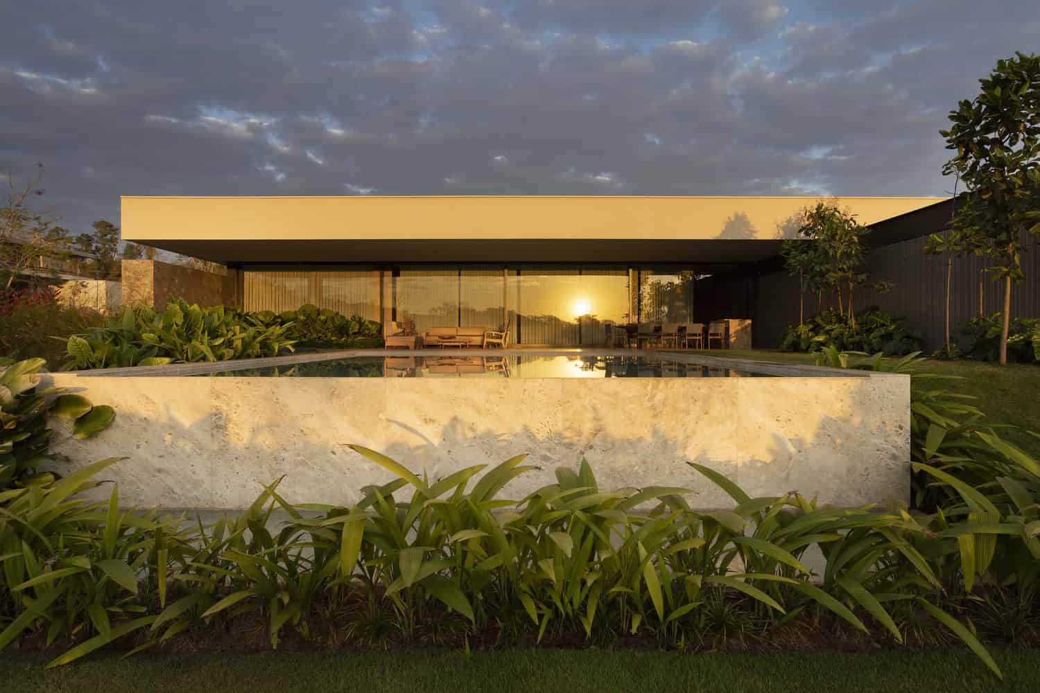 FE House by N2B Arquitetura pool and rear facade at sunset in Ribeirão Preto, Brazil