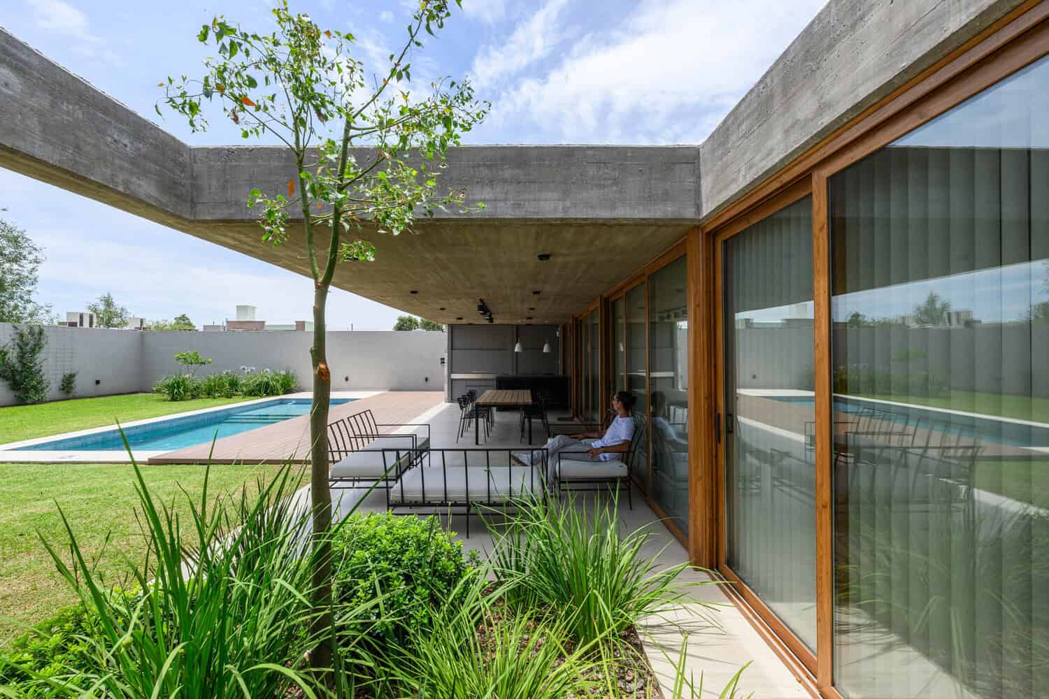 House G by Karlen + Clemente — terrace lounge beside pool, Río Tercero