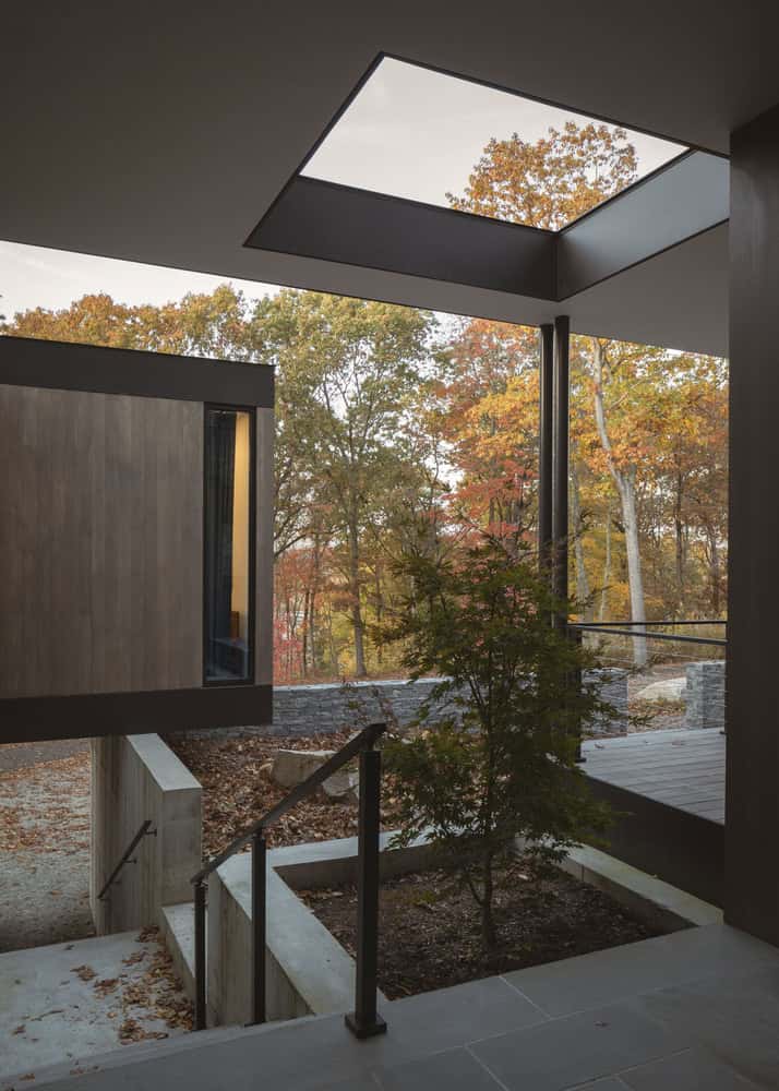 House in the Woods by Tom Lontine Architect, courtyard stair and lightwell with tree in Connecticut