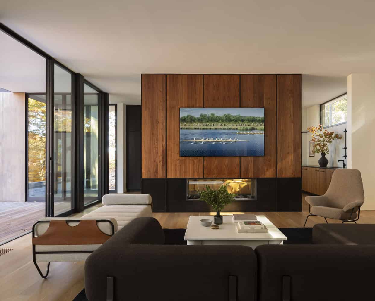 House in the Woods by Tom Lontine Architect, living room fireplace wall with wood paneling in Connecticut