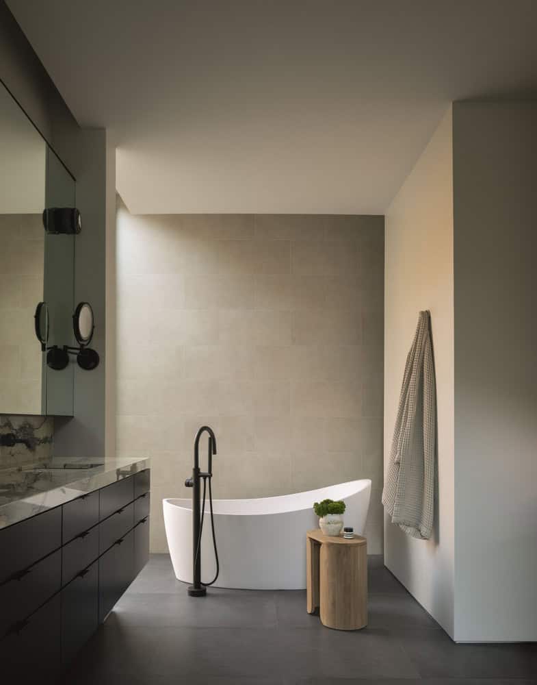 House in the Woods by Tom Lontine Architect, primary bathroom with freestanding tub and soft natural light in Connecticut