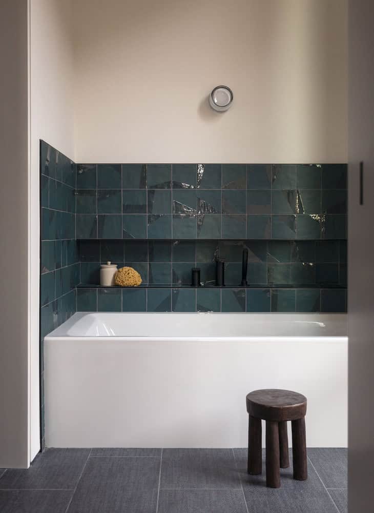 House in the Woods bathroom with green tiles and soaking tub in Connecticut by Tom Lontine Architect