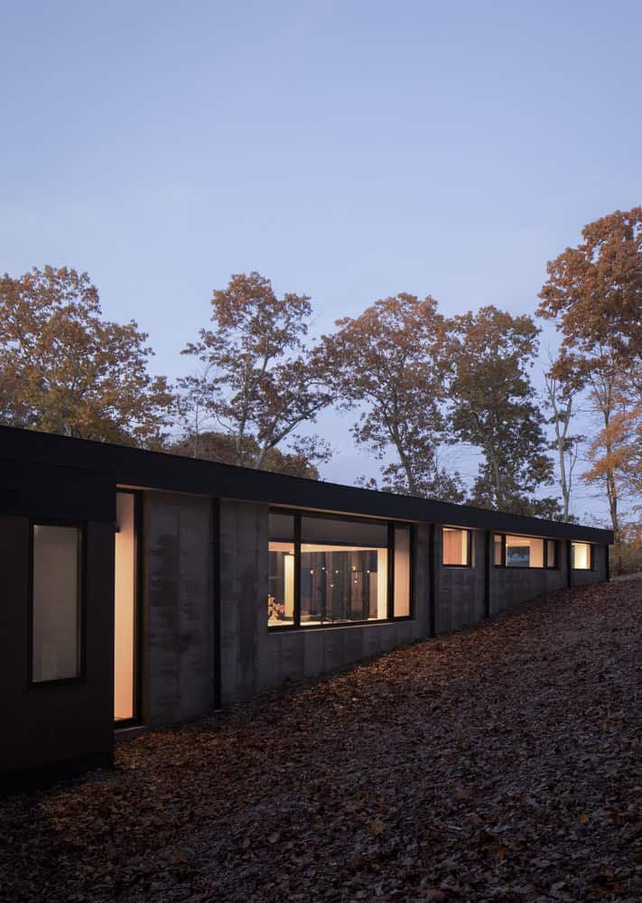 House in the Woods concrete and wood elevation on forested hillside in Connecticut by Tom Lontine Architect