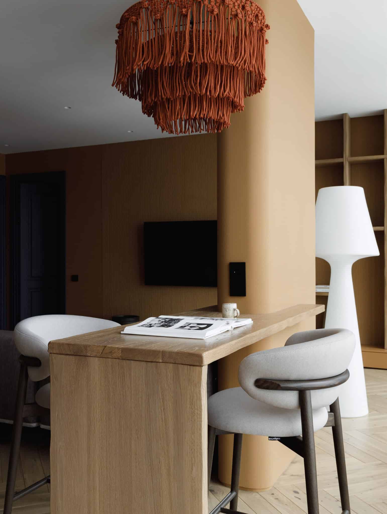 Lesoparkovy Apartment by STARIKOVA.ARCHITECTS bar counter with sculptural pendant light in Chelyabinsk, Russia