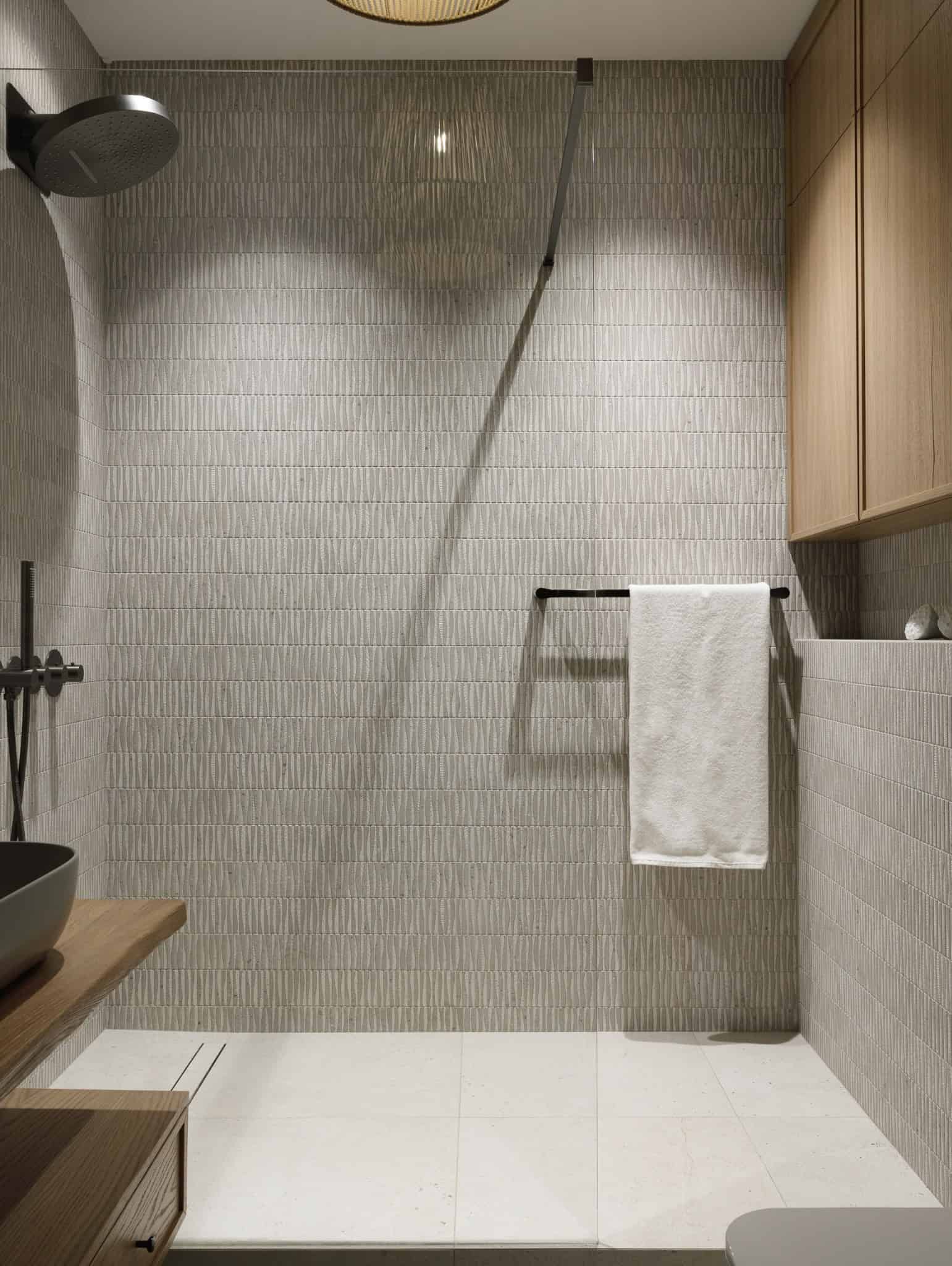 Walk-in shower with textured tiles in Lesoparkovy Apartment by STARIKOVA.ARCHITECTS