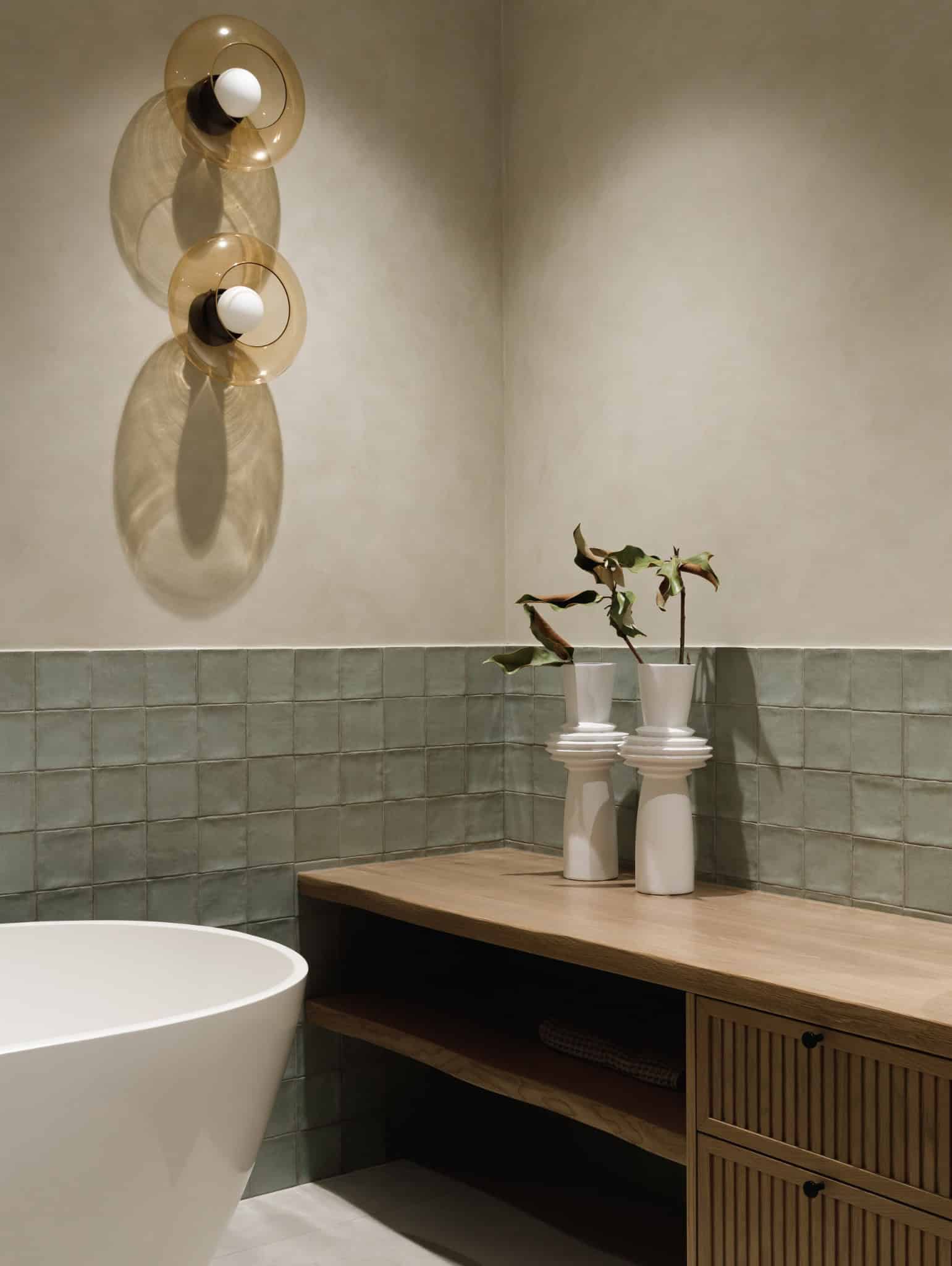 Decorative vases on wood vanity in Lesoparkovy Apartment bathroom by STARIKOVA.ARCHITECTS