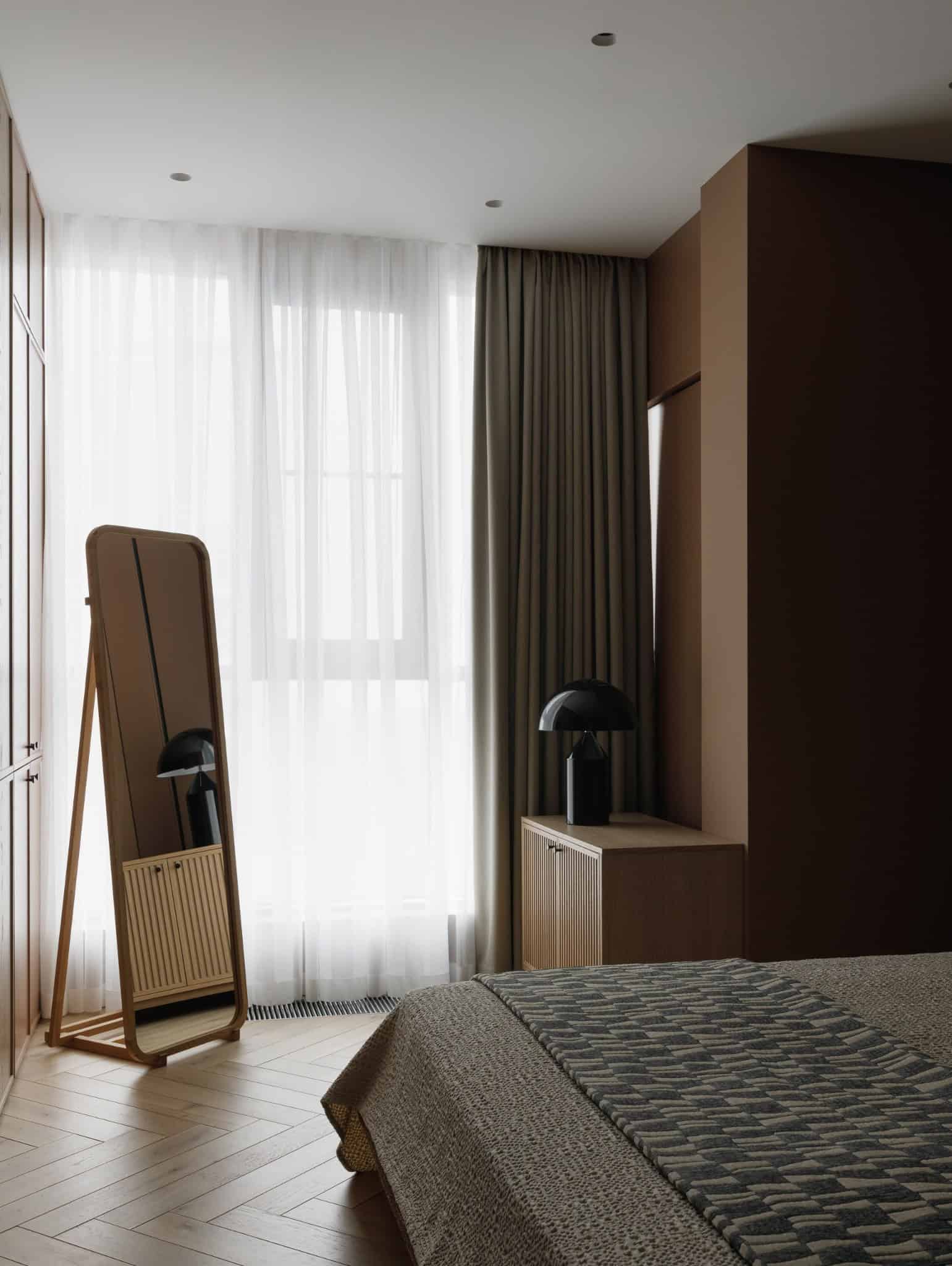 Bedroom with soft window light and standing mirror in Lesoparkovy Apartment by STARIKOVA.ARCHITECTS