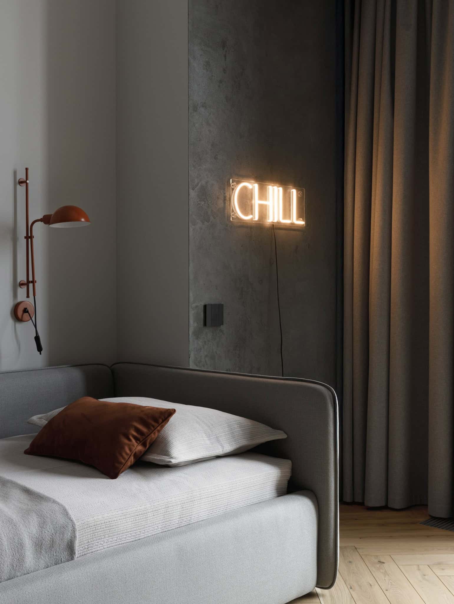 Kids bedroom with neon chill sign and grey bed in Lesoparkovy Apartment by STARIKOVA.ARCHITECTS