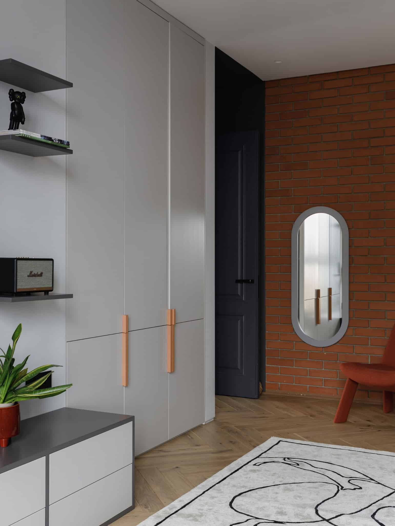 Kids room wardrobe and brick wall in Lesoparkovy Apartment by STARIKOVA.ARCHITECTS