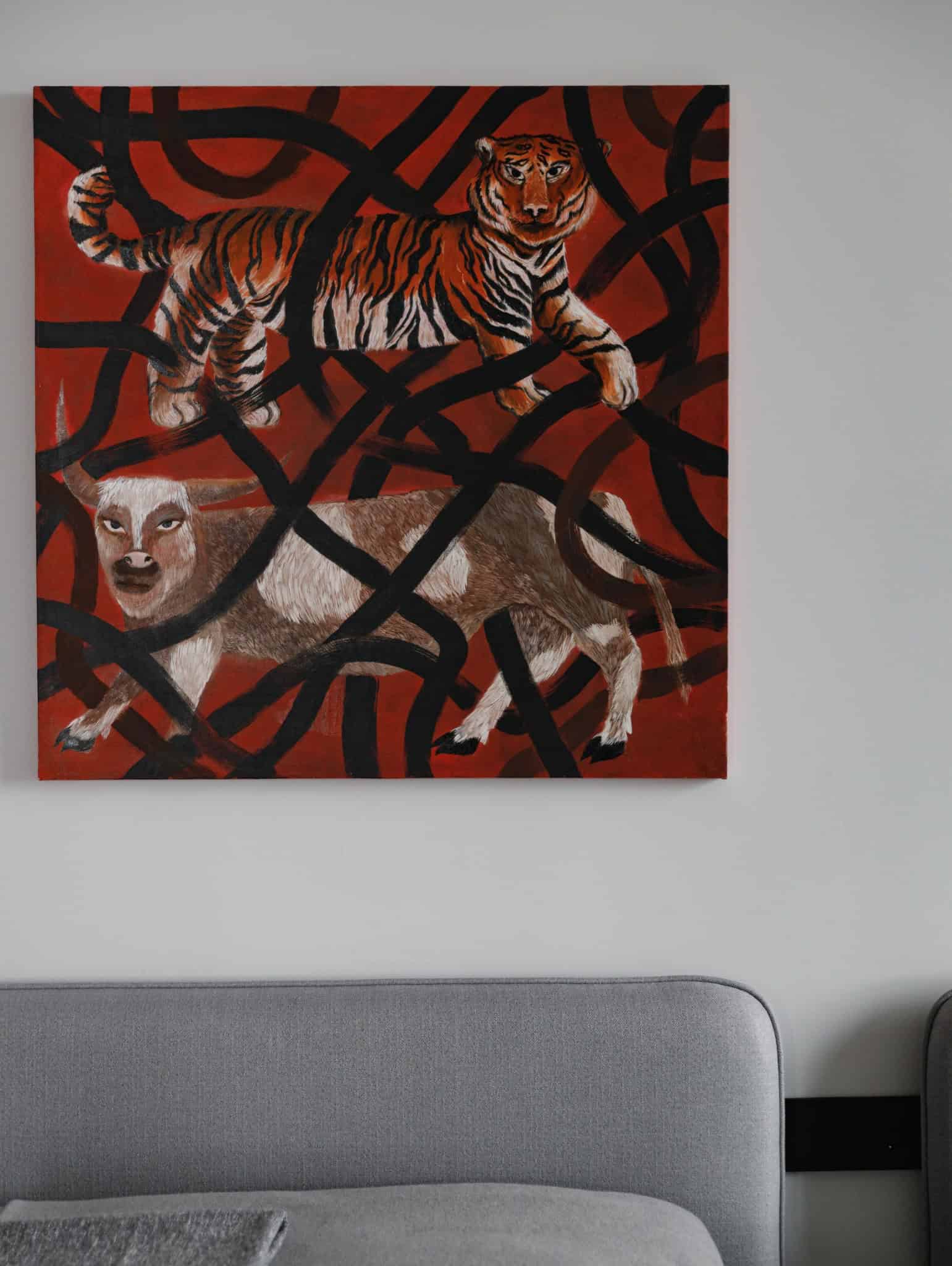 Lesoparkovy Apartment living room with bold animal artwork above grey sofa by STARIKOVA.ARCHITECTS in Chelyabinsk, Russia