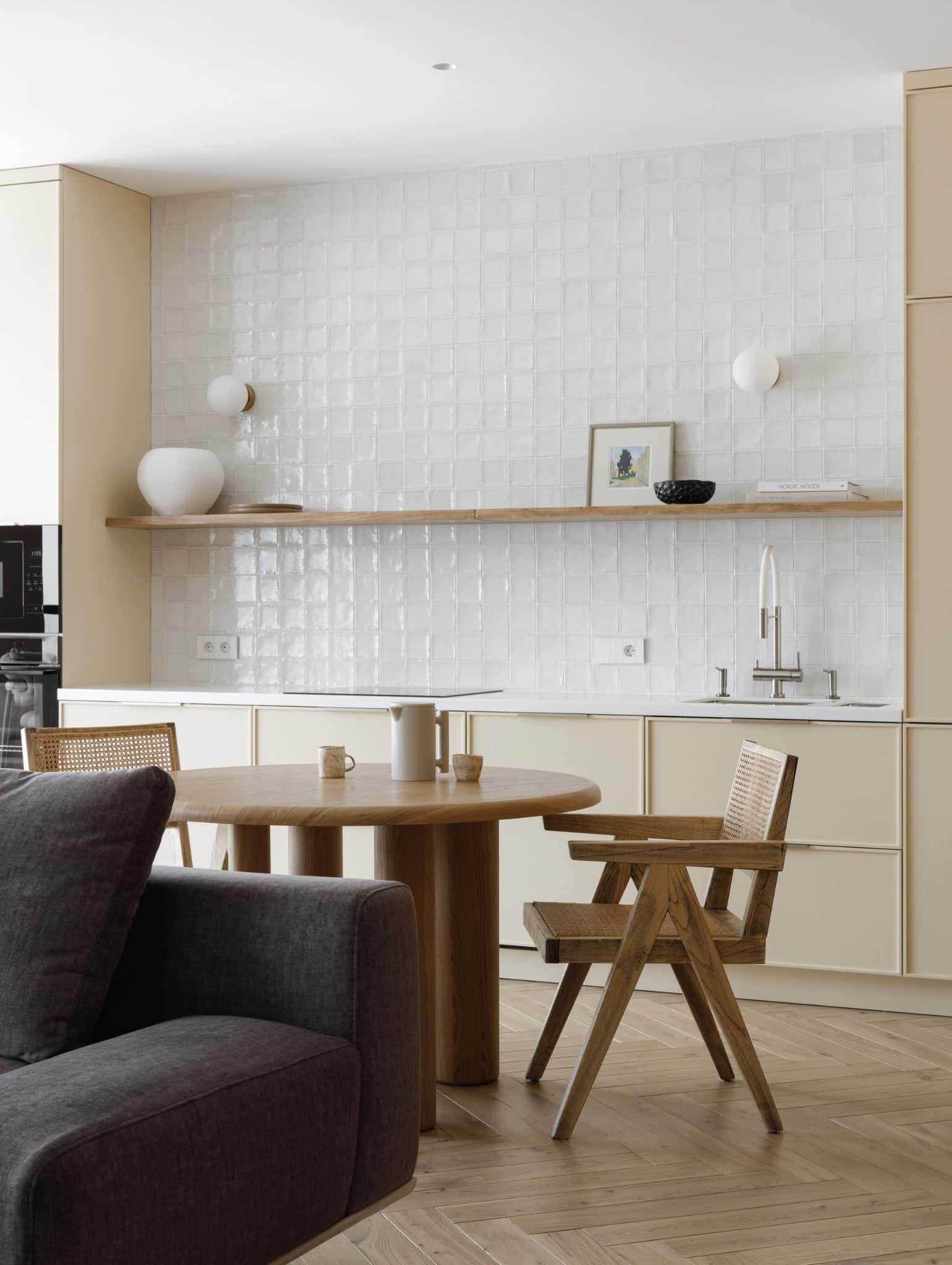 Lesoparkovy Apartment by STARIKOVA.ARCHITECTS living room sofa facing warm-toned kitchen in Chelyabinsk, Russia