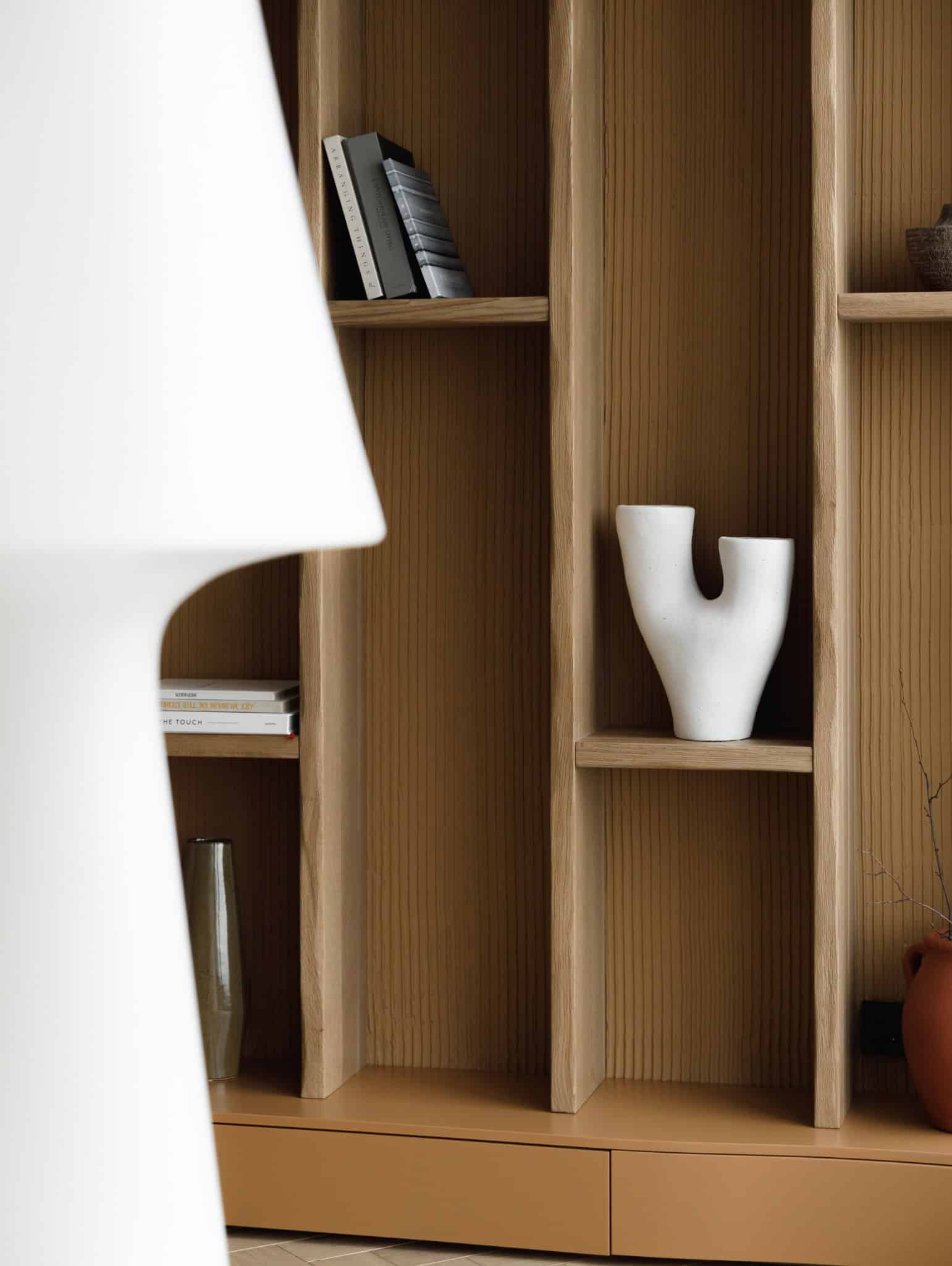 Lesoparkovy Apartment living room shelves with sculptural white vase by STARIKOVA.ARCHITECTS in Chelyabinsk, Russia