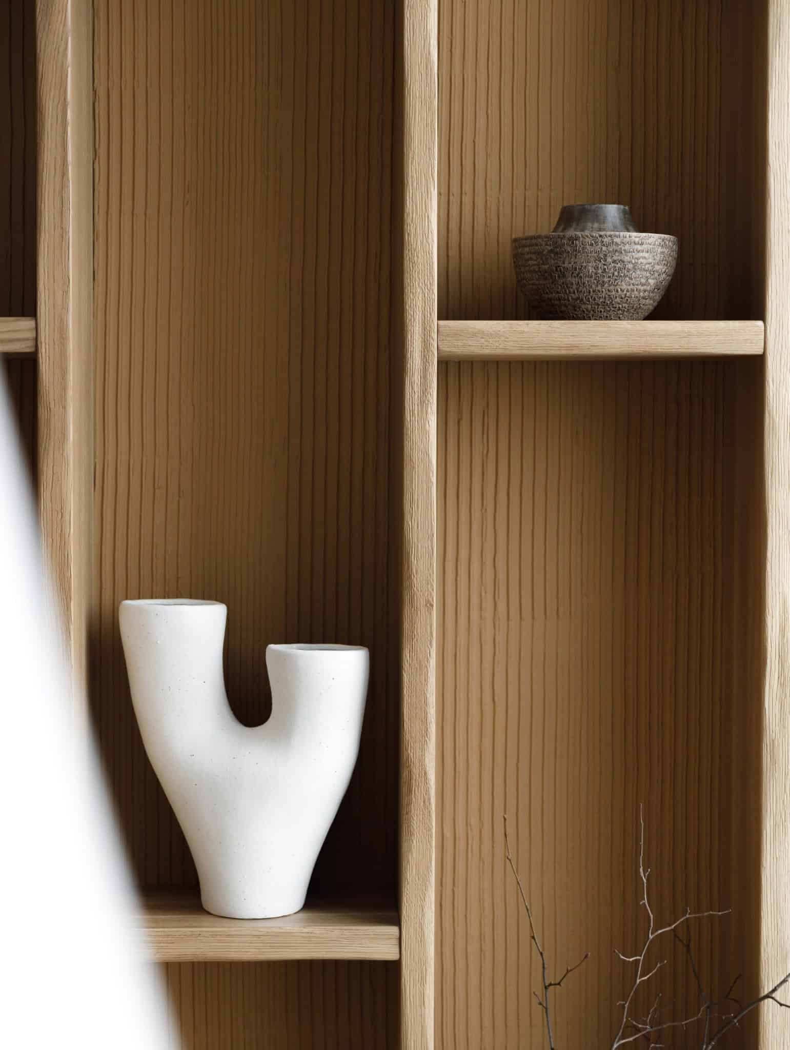 Detail of textured shelves and ceramic vase in Lesoparkovy Apartment by STARIKOVA.ARCHITECTS in Chelyabinsk, Russia