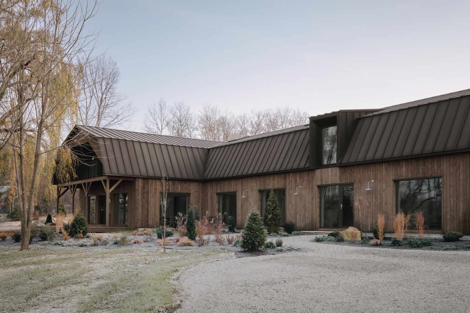 Maison Melba by Atelier L’Abri L-shaped courtyard wing with garden landscaping in Frelighsburg, Quebec