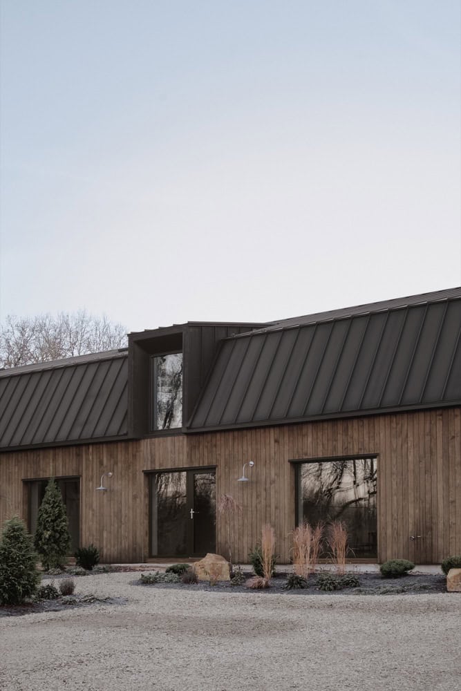 Detail of Maison Melba by Atelier L’Abri with metal-clad dormer above entry facade in Frelighsburg, Quebec