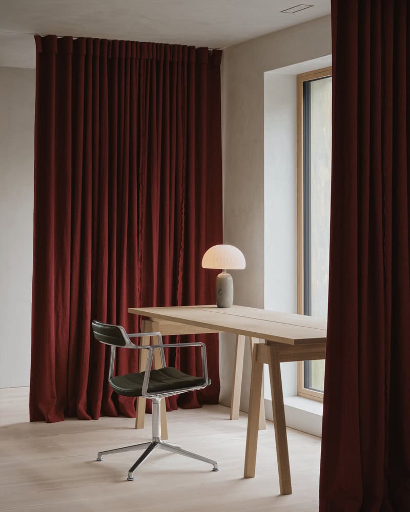Maison Melba home office by Atelier L’Abri with red curtains, wood desk and modern task chair in Frelighsburg, Quebec