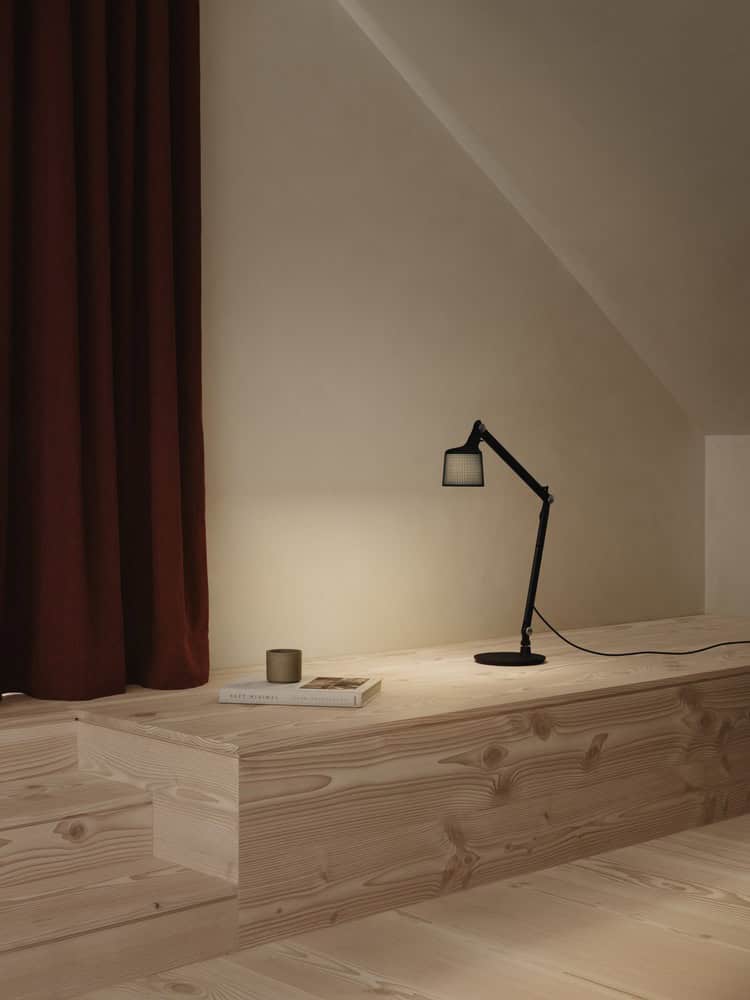 Maison Melba cozy reading nook by Atelier L’Abri with red curtains, timber platform and task lamp in Frelighsburg, Quebec