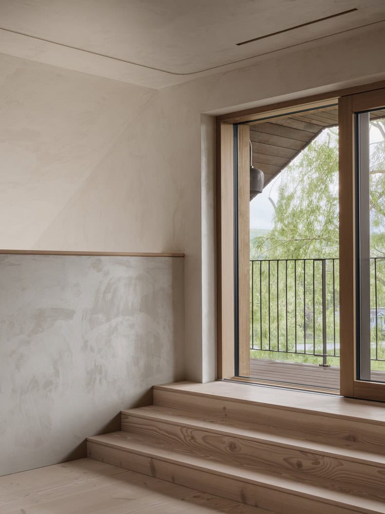 Maison Melba stair landing by Atelier L’Abri with steps leading to balcony door and railing in Frelighsburg, Quebec
