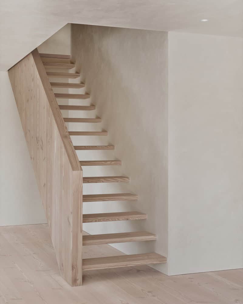 Maison Melba interior by Atelier L’Abri featuring minimalist wooden floating staircase in Frelighsburg Quebec