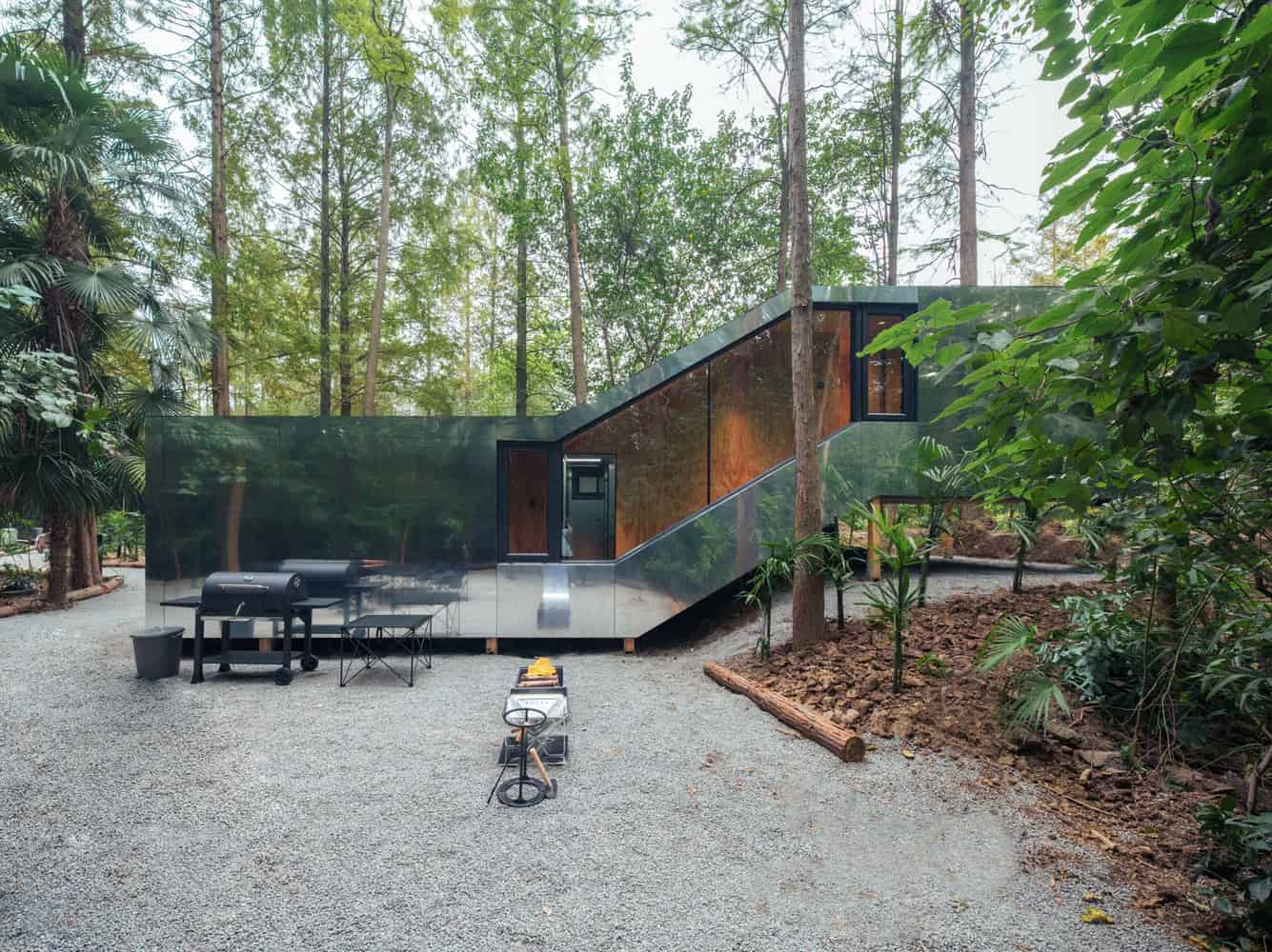 Merryda Wiki World-Secret Camp Day Side Elevation Terrace by Wiki World + Advanced Architecture Lab Daytime side elevation of Merryda Wiki World-Secret Camp by Wiki World + Advanced Architecture Lab with mirrored façade and outdoor terrace in China