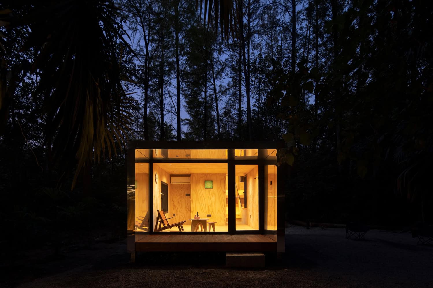 Merryda Wiki World-Secret Camp Night Front Living Room by Wiki World + Advanced Architecture Lab Front night view of Merryda Wiki World-Secret Camp by Wiki World + Advanced Architecture Lab showing illuminated living room in China