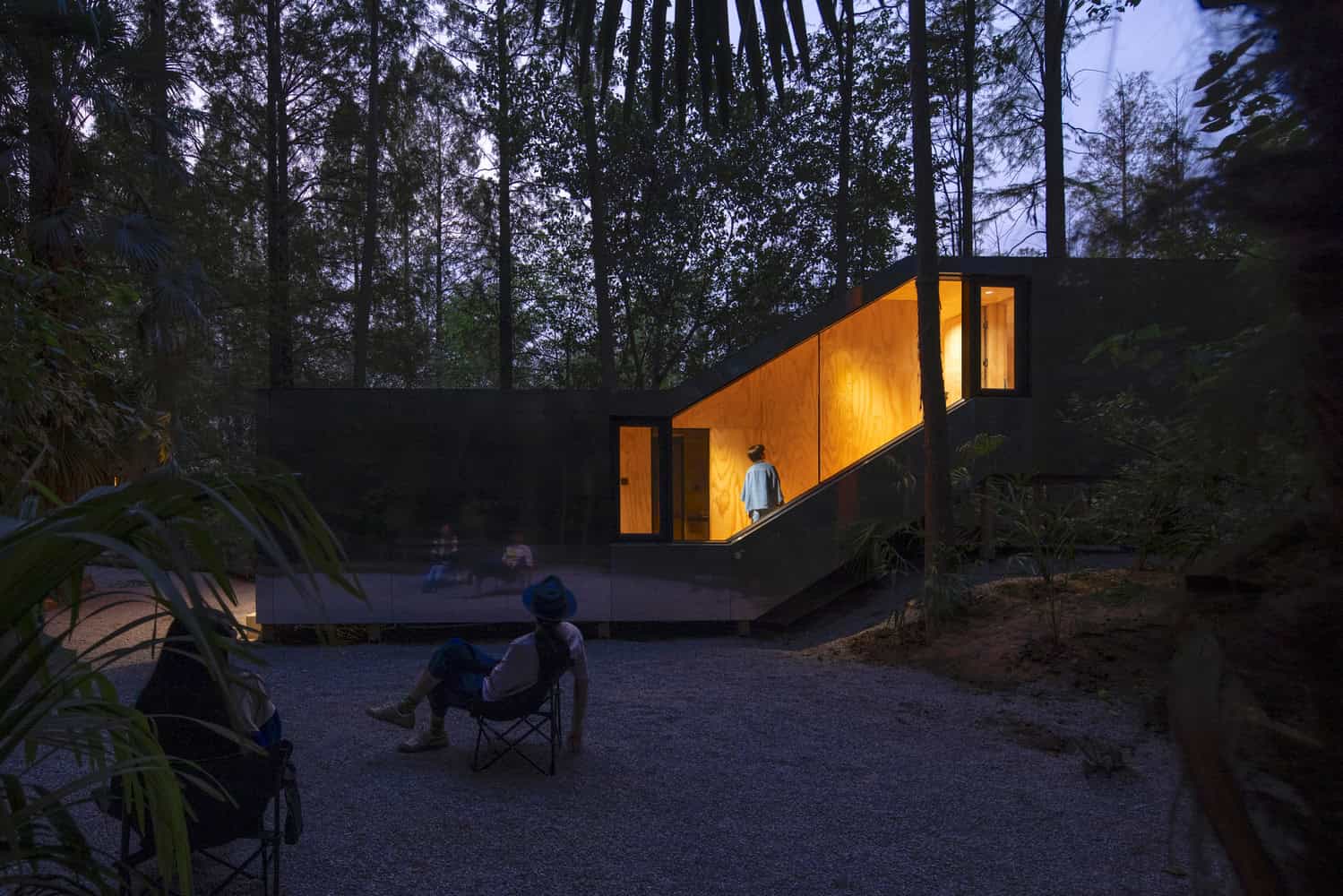 Merryda Wiki World-Secret Camp Night Side Lit Corridor by Wiki World + Advanced Architecture Lab Night side view of Merryda Wiki World-Secret Camp by Wiki World + Advanced Architecture Lab with illuminated timber corridor in China