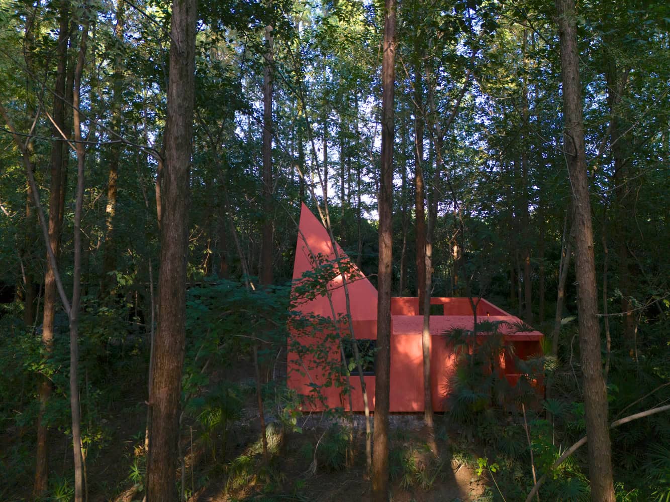 Merryda Wiki World-Secret Camp Pink Cabin Side Forest by Wiki World + Advanced Architecture Lab Side view of pink cabin at Merryda Wiki World-Secret Camp by Wiki World + Advanced Architecture Lab set in dense forest in China
