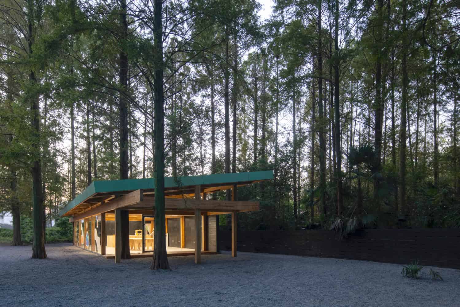 Merryda Wiki World-Secret Camp Forest Wood Pavilion Exterior Dusk by Wiki World + Advanced Architecture Lab Forest pavilion of Merryda Wiki World-Secret Camp by Wiki World + Advanced Architecture Lab in China at dusk