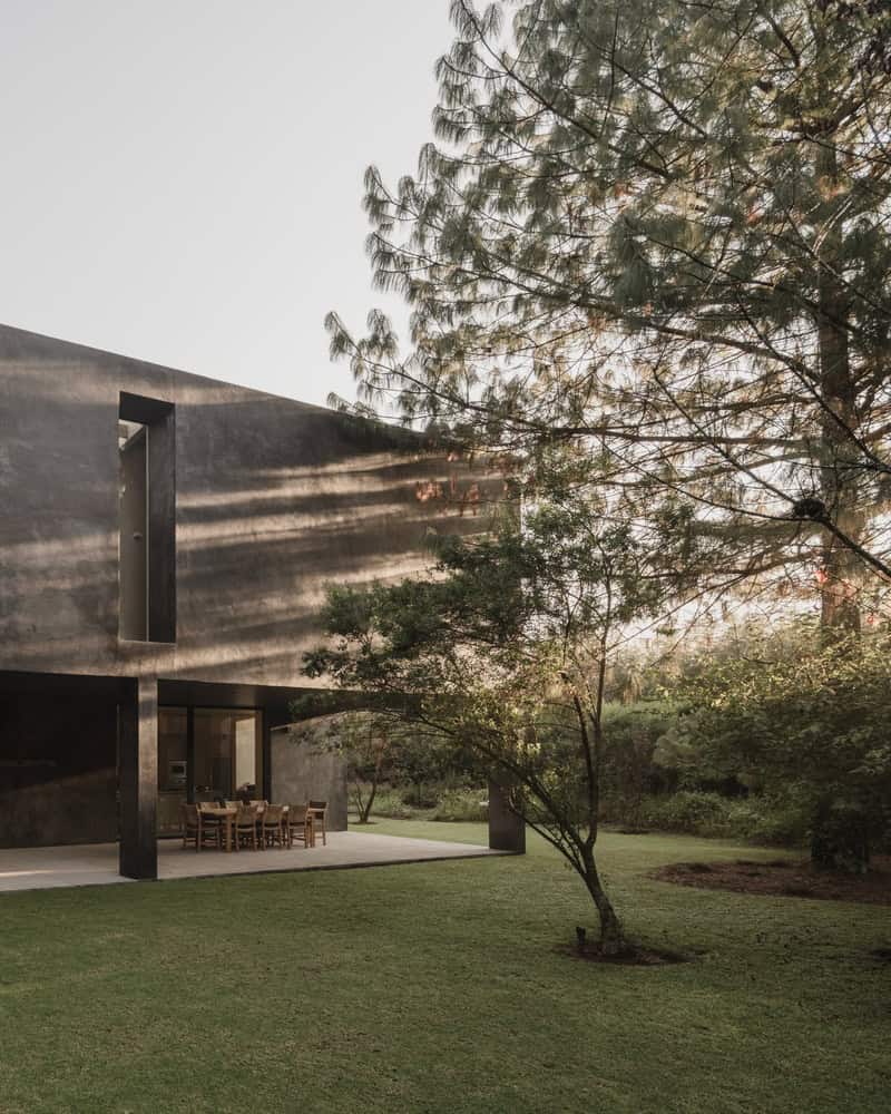 Ocote House by PPAA, covered terrace opening to lawn, Mexico