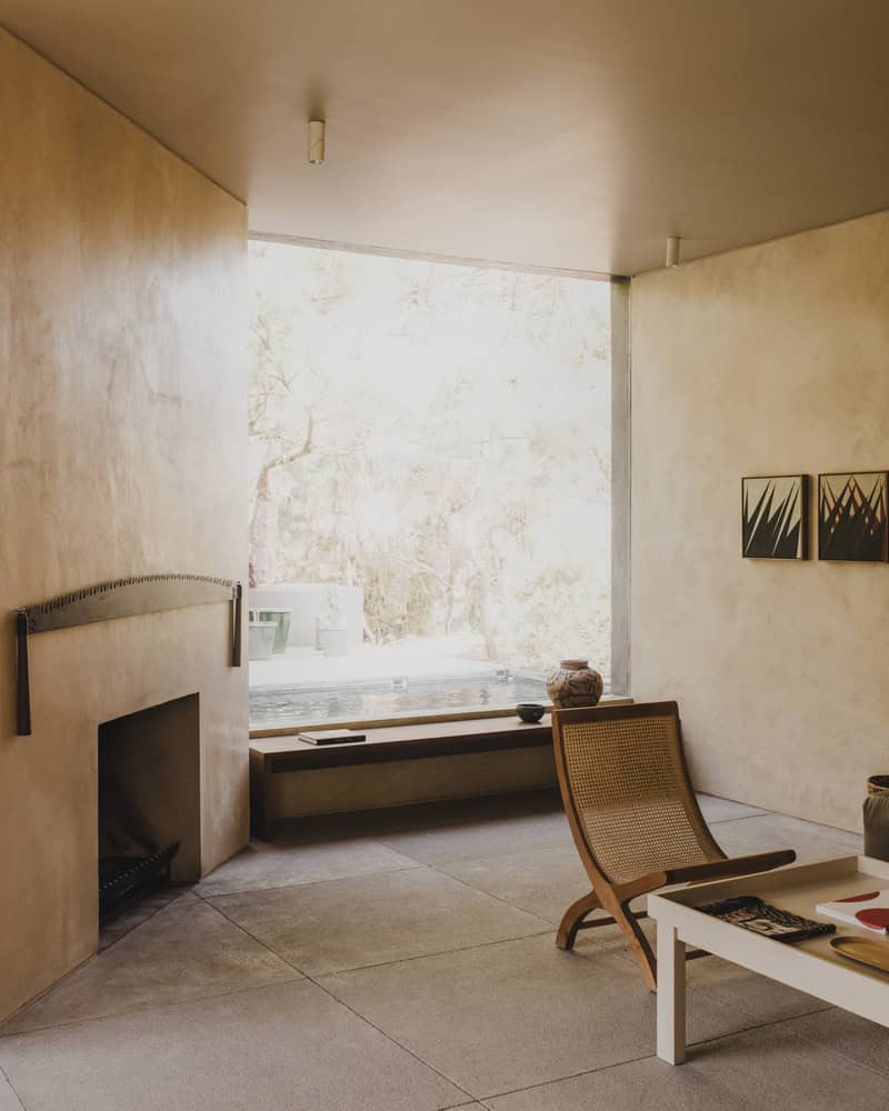 Ocote House by PPAA, living room with fireplace and window, Mexico
