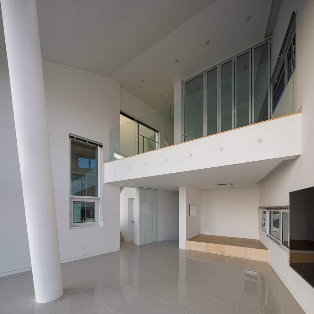 Pacific Residence by Moon Hoon double height living space with balcony in Seogwipo