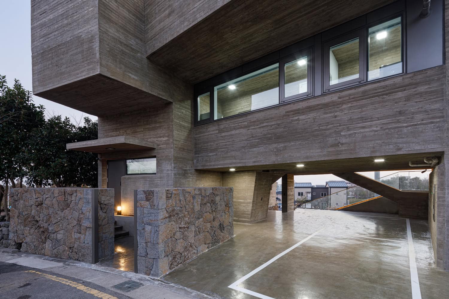 Pacific Residence by Moon Hoon ground level parking entrance under cantilever in Seogwipo