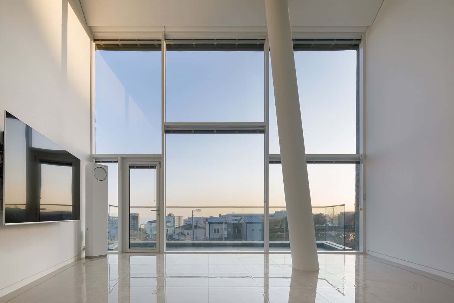 Pacific Residence by Moon Hoon panoramic living room windows facing Seogwipo city