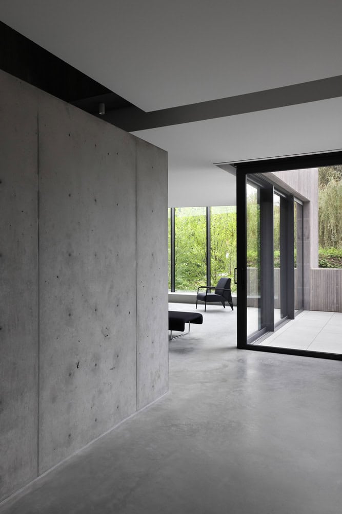 Re-folded House by McLeod Bovell Modern Houses, concrete corridor leading to patio, Vancouver