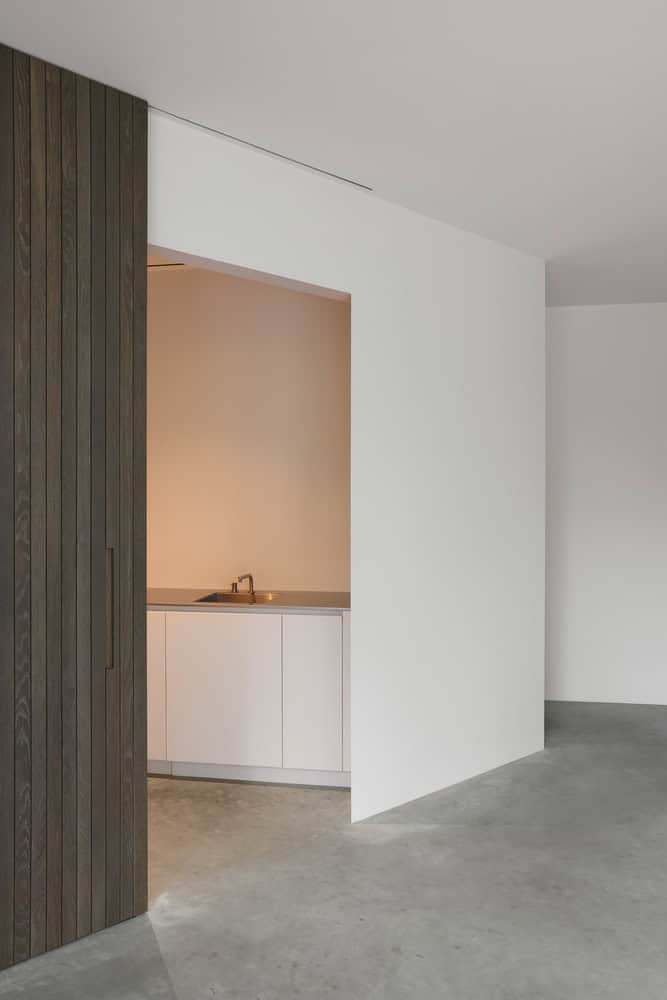 Re-folded House by McLeod Bovell Modern Houses, kitchenette niche behind sliding door, Vancouver