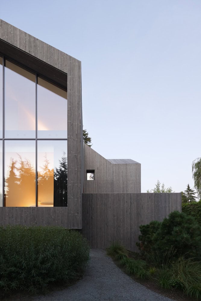Re-folded House by McLeod Bovell Modern Houses, side gable exterior at evening, Vancouver