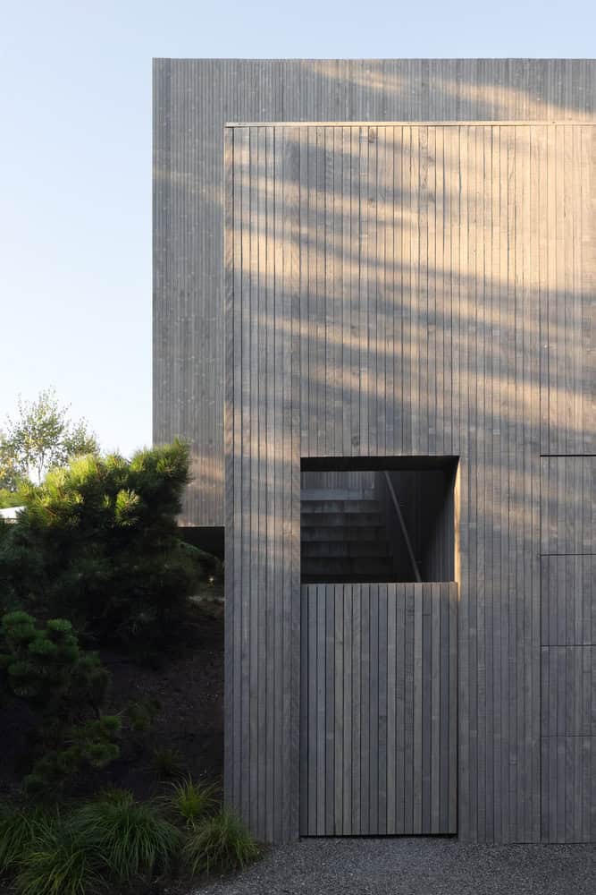 Re-folded House by McLeod Bovell Modern Houses, stair entrance framed with wood cladding, Vancouver