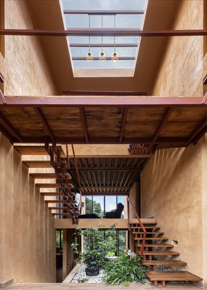Central atrium of The Sierra House by Valdez Arquitectos with floating staircases, skylight and indoor garden in Chiapas, Mexico