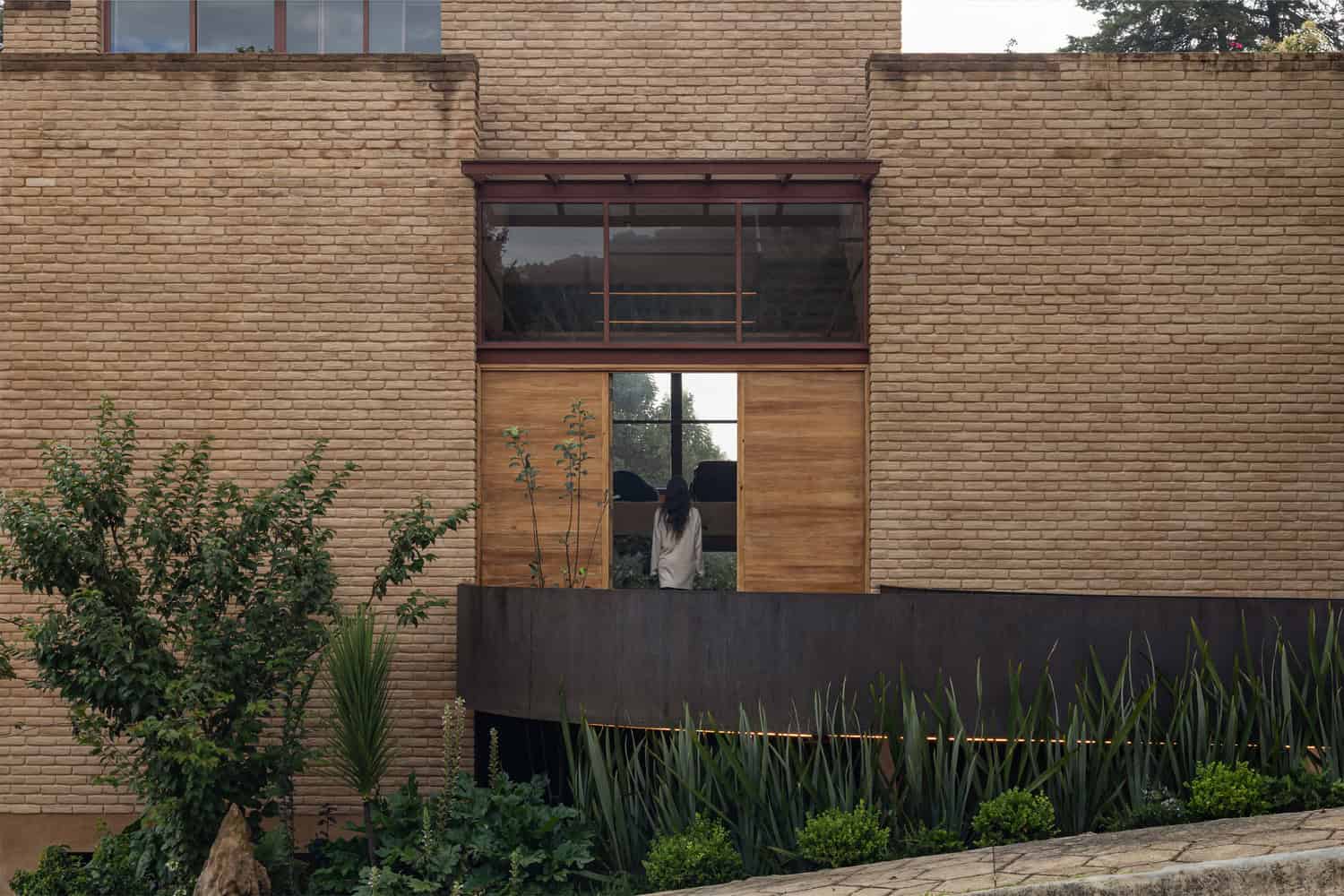Detail of The Sierra House entrance balcony and sliding wood doors by Valdez Arquitectos in Chiapas, Mexico