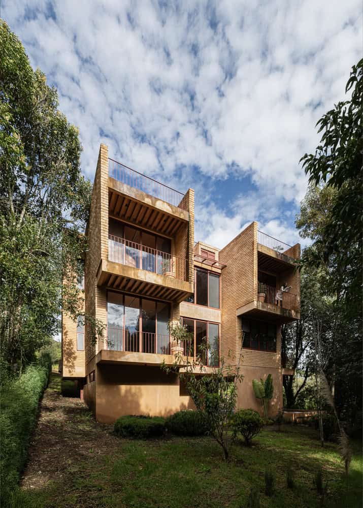Garden facade of The Sierra House by Valdez Arquitectos with stacked terraces and large windows in Chiapas, Mexico
